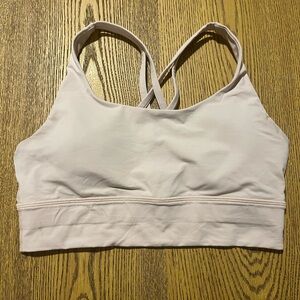 Lululemon light pink sports bra w/ cross back straps and removable pads. Size 8.